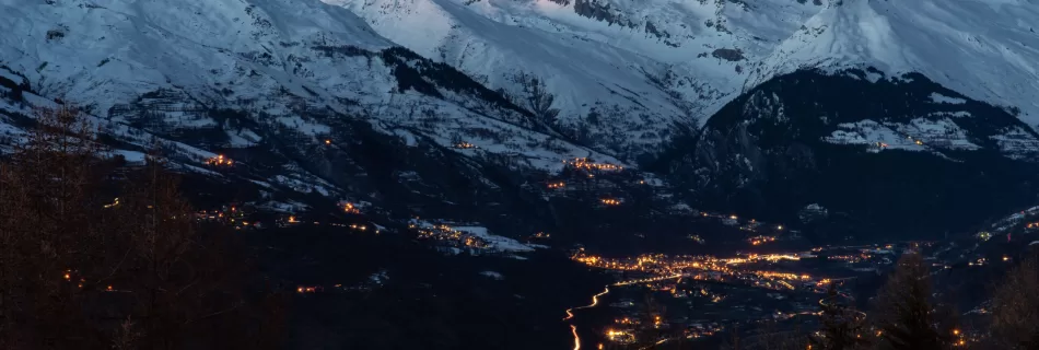 A long exposure as lights twinkle on in the French Alps